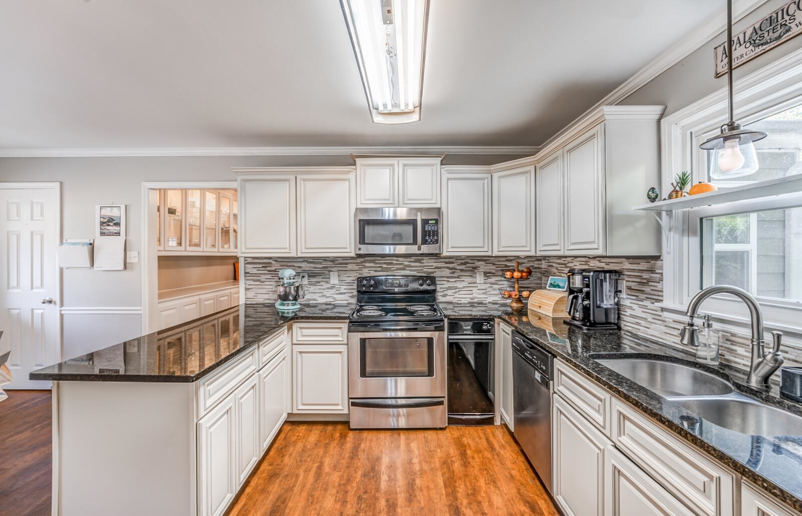 453 Fleda Road Memphis, TN 38120 - Photo 15 of 31 a kitchen with stainless steel appliances granite countertop a stove and a sink