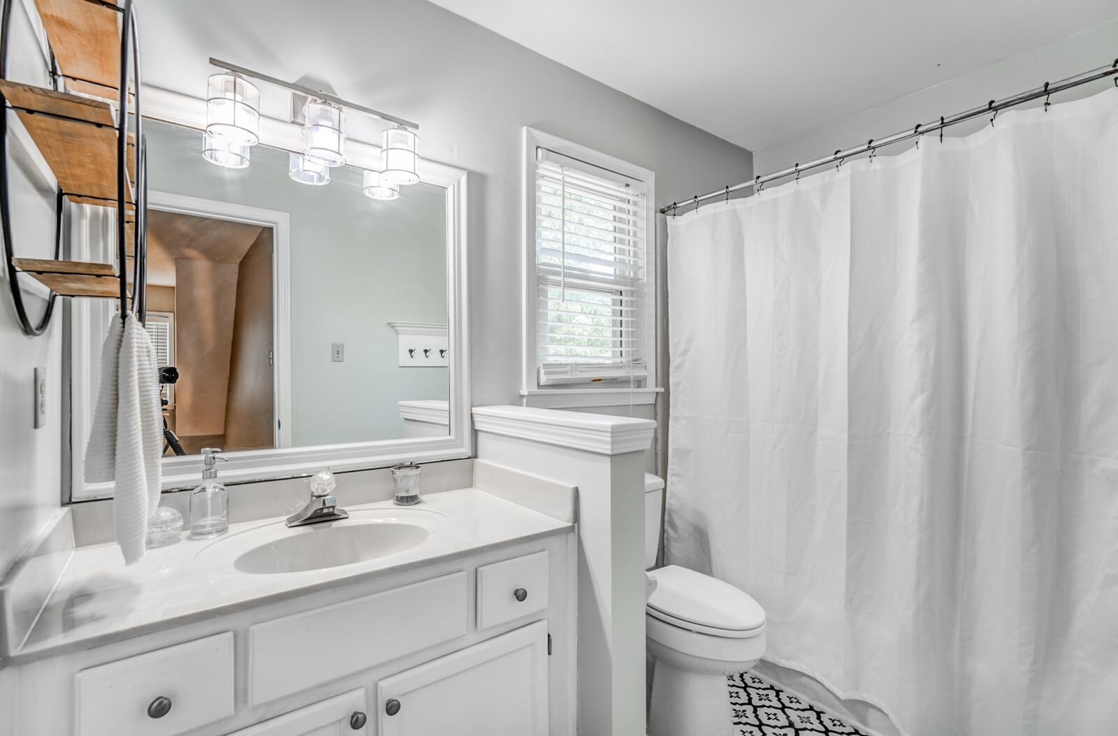 453 Fleda Road Memphis, TN 38120 - Photo 26 of 31 a bathroom with a granite countertop sink toilet and mirror