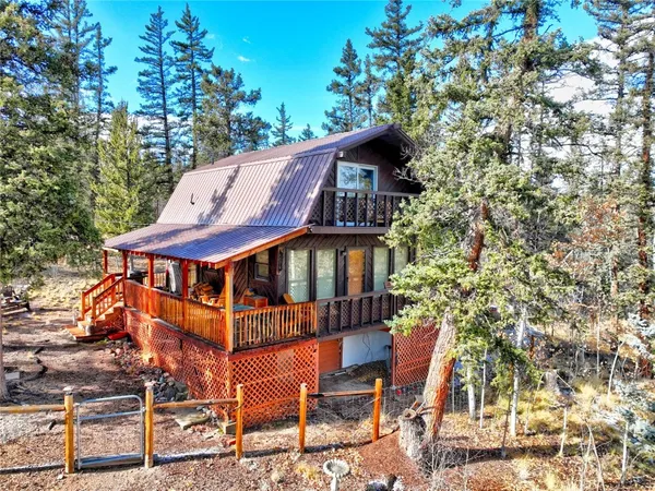 a white house with a tree in the background