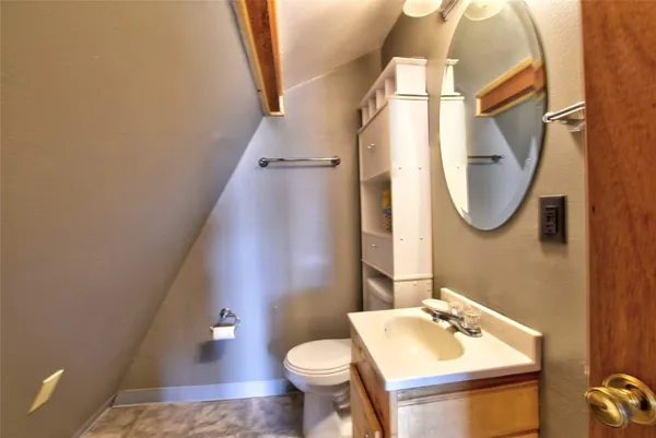 a bathroom with a sink toilet and mirror