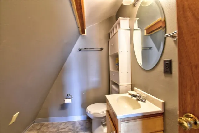 a bathroom with a sink toilet and mirror