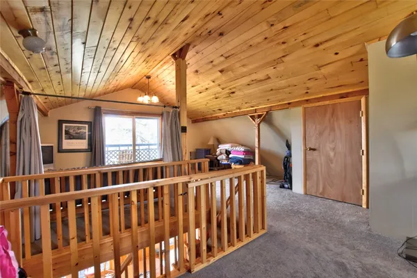 a view of a porch with wooden floor and iron fence