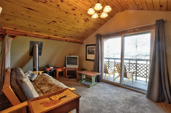 a living room with furniture a flat screen tv and a large window