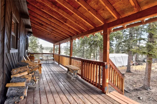 a view of balcony with wooden floor and outdoor seating