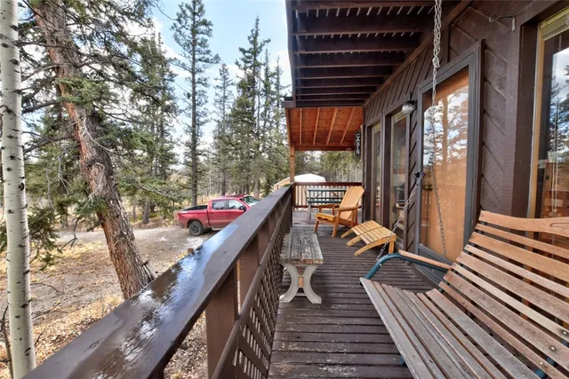 a view of balcony with wooden floor and outdoor seating