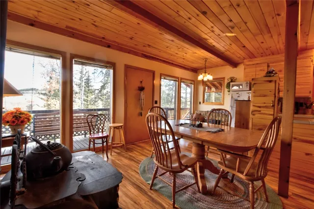a dining room with furniture and wooden floor