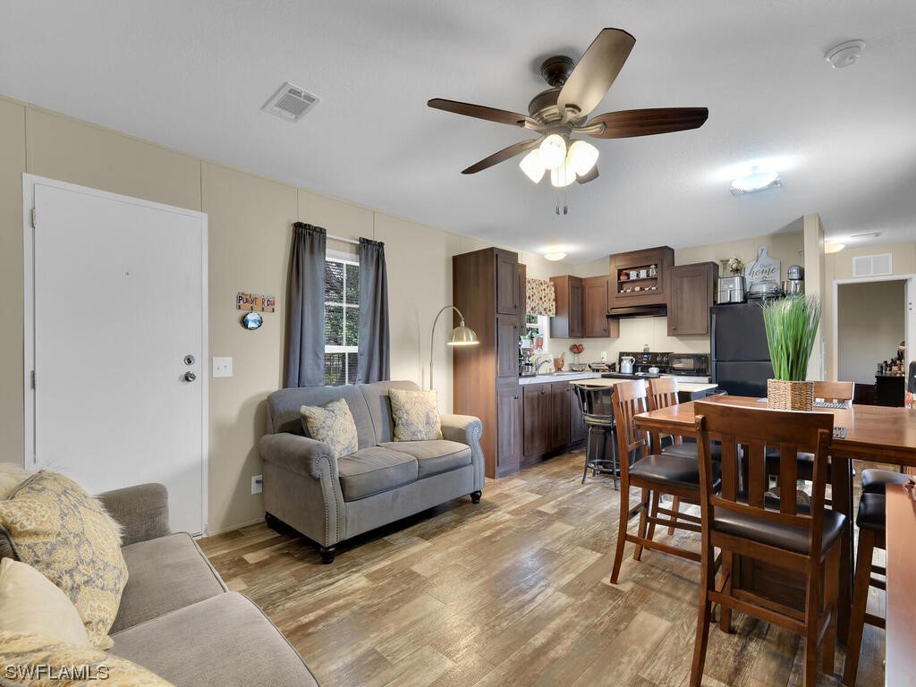 1183 Summerall Road LaBelle, FL 33935 - Photo 11 of 28 a living room with furniture kitchen view and a chandelier