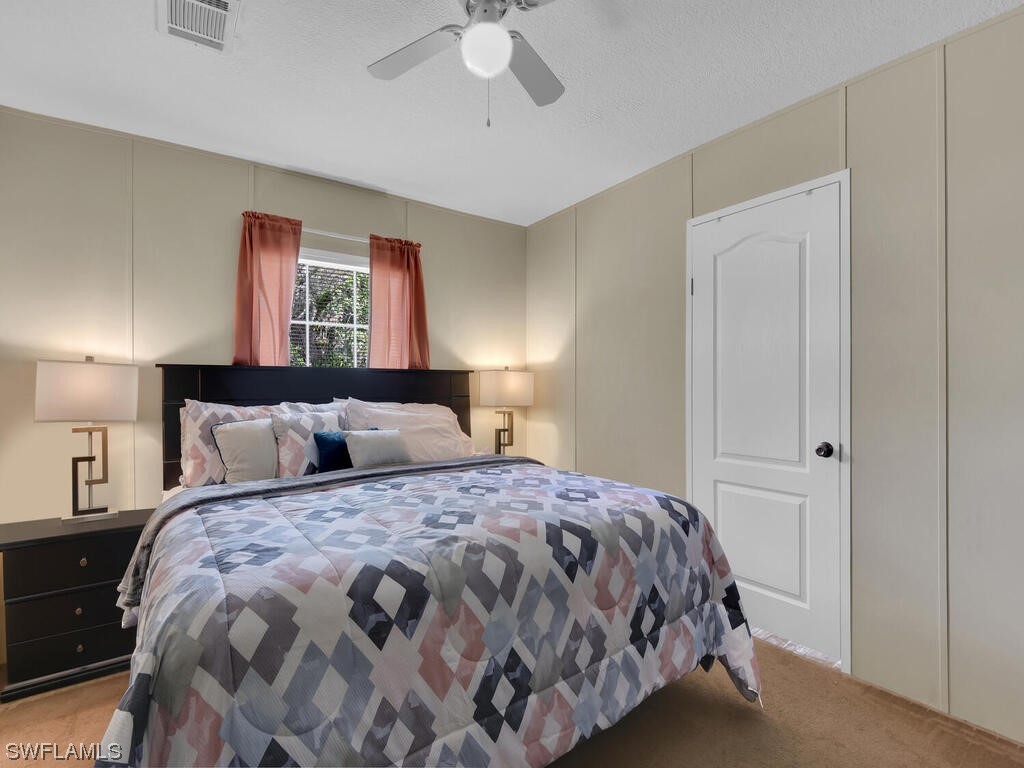 1183 Summerall Road LaBelle, FL 33935 - Photo 12 of 28 a bedroom with a bed and a chandelier