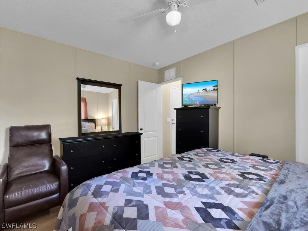 1183 Summerall Road LaBelle, FL 33935 - Photo 13 of 28 a bedroom with a bed and a dresser