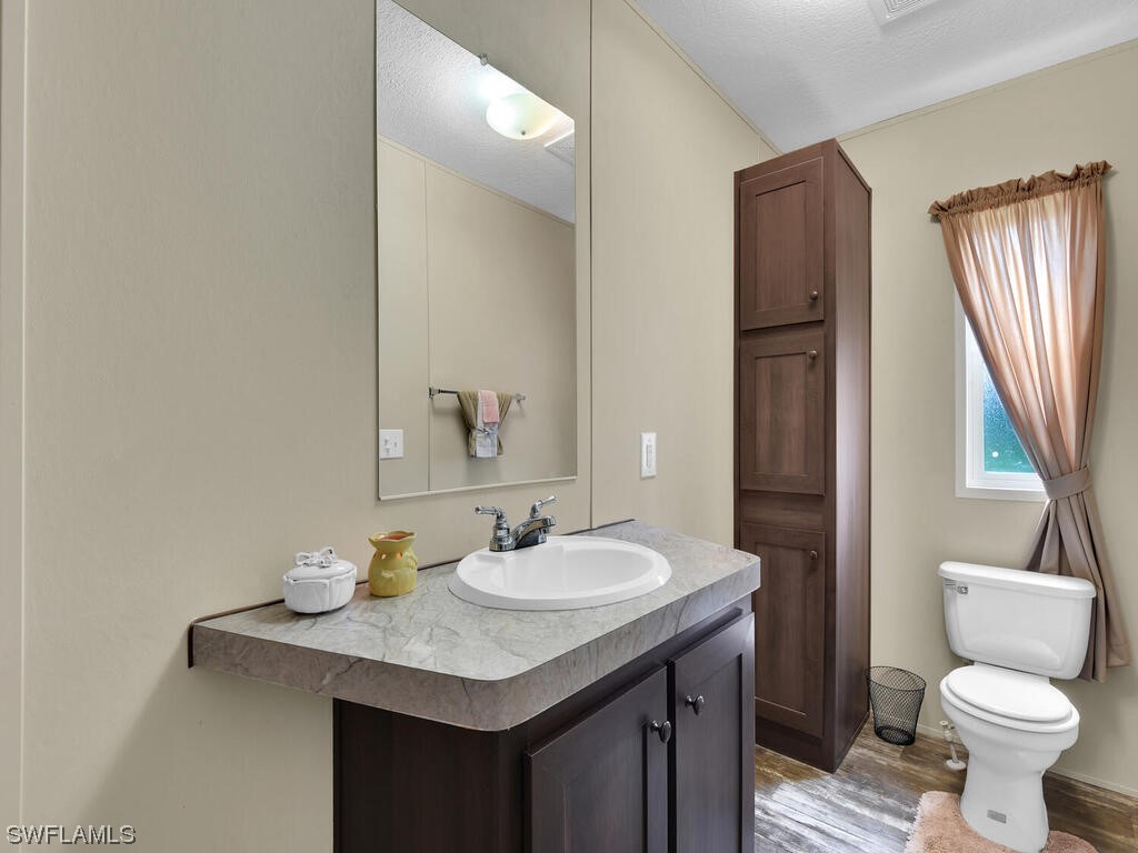 1183 Summerall Road LaBelle, FL 33935 - Photo 15 of 28 a bathroom with a sink toilet and a mirror