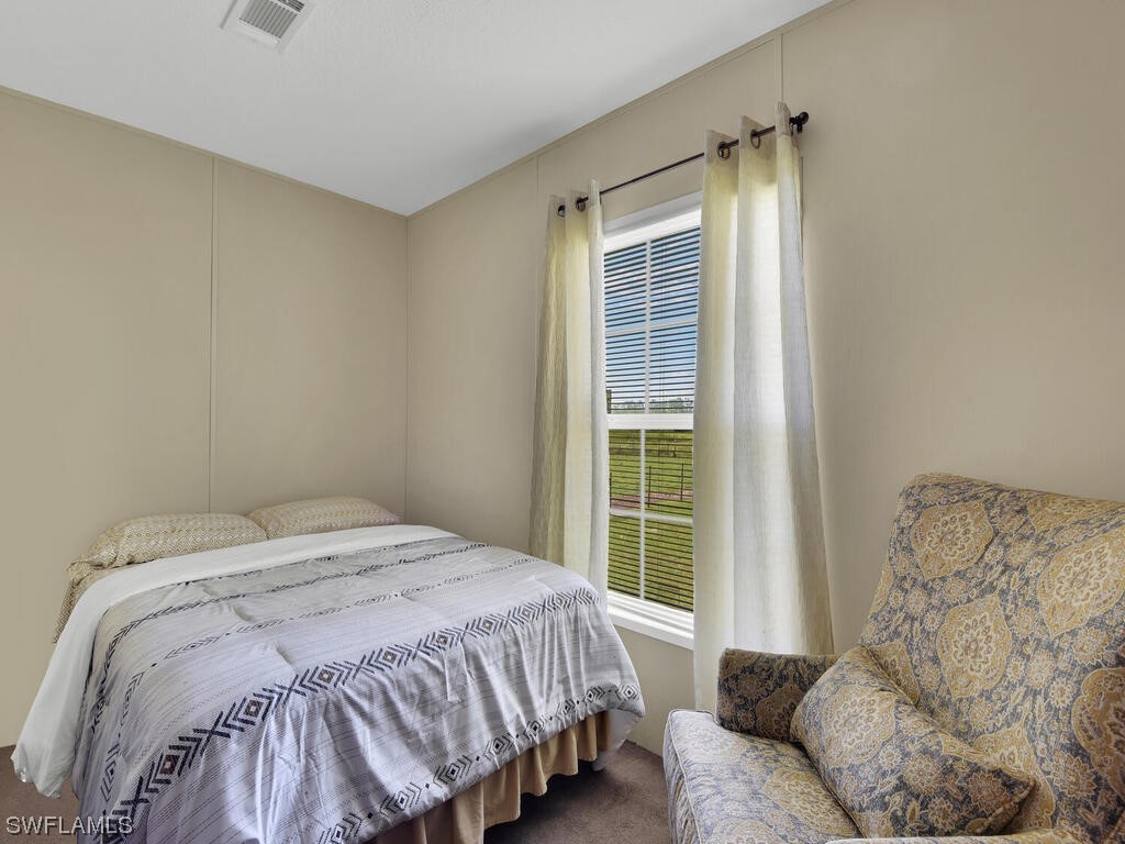 1183 Summerall Road LaBelle, FL 33935 - Photo 16 of 28 a bedroom with a bed and a window
