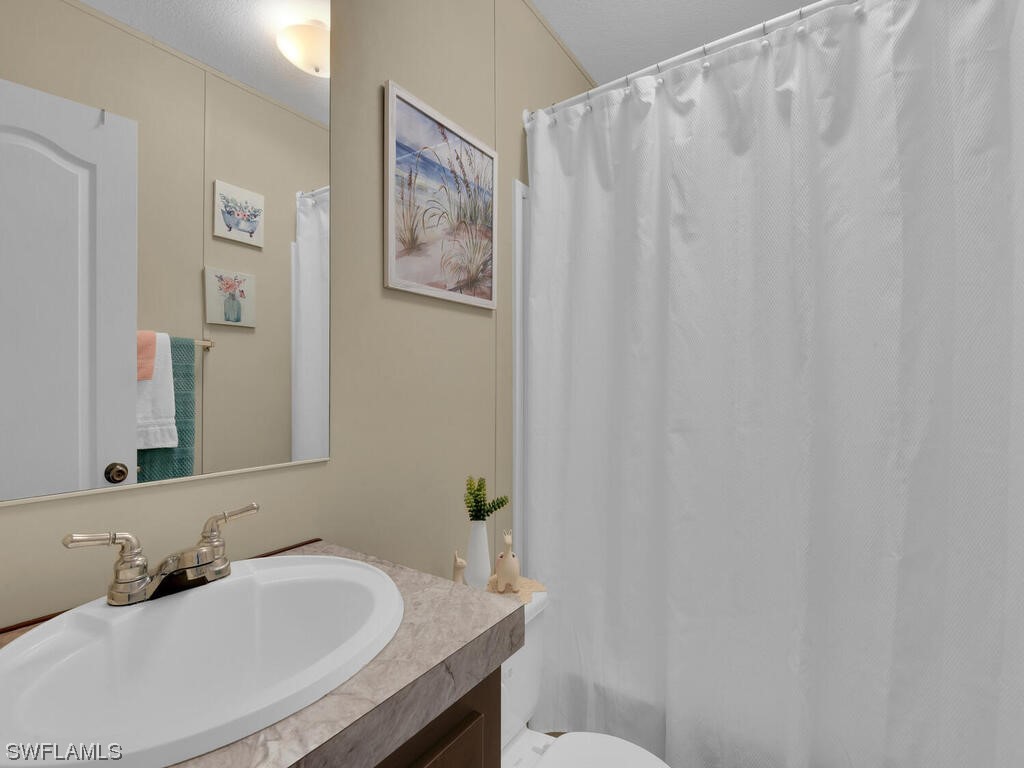 1183 Summerall Road LaBelle, FL 33935 - Photo 18 of 28 a bathroom with a sink and a mirror