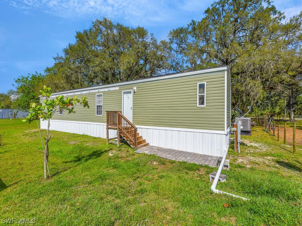 1183 Summerall Road LaBelle, FL 33935 - Photo 22 of 28 a view of a backyard with a large tree