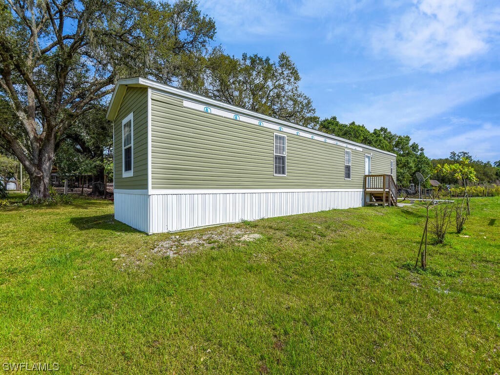 1183 Summerall Road LaBelle, FL 33935 - Photo 23 of 28 a backyard of a house with plants and tree