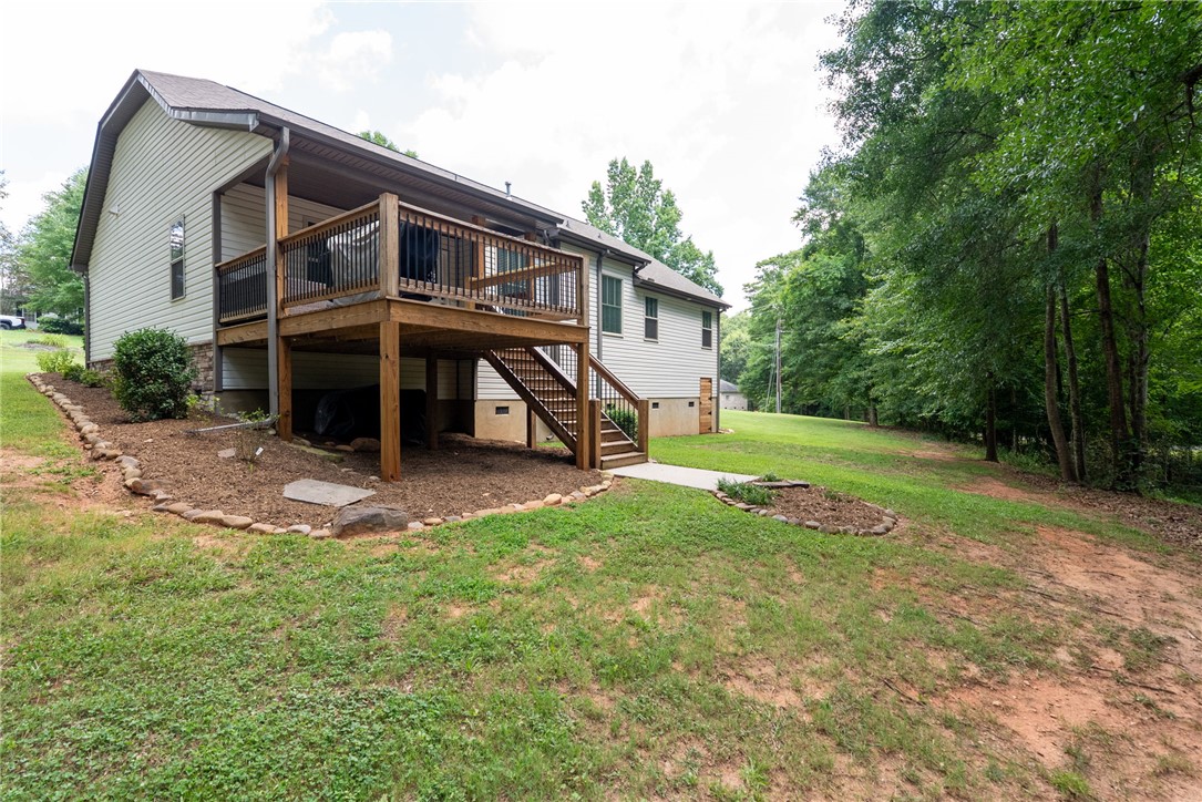 201 Hearthstone Drive Anderson, SC 29621 - Photo 47 of 49 A spacious elevated deck extends from the residence, overlooking an expansive, tree-lined yard.
