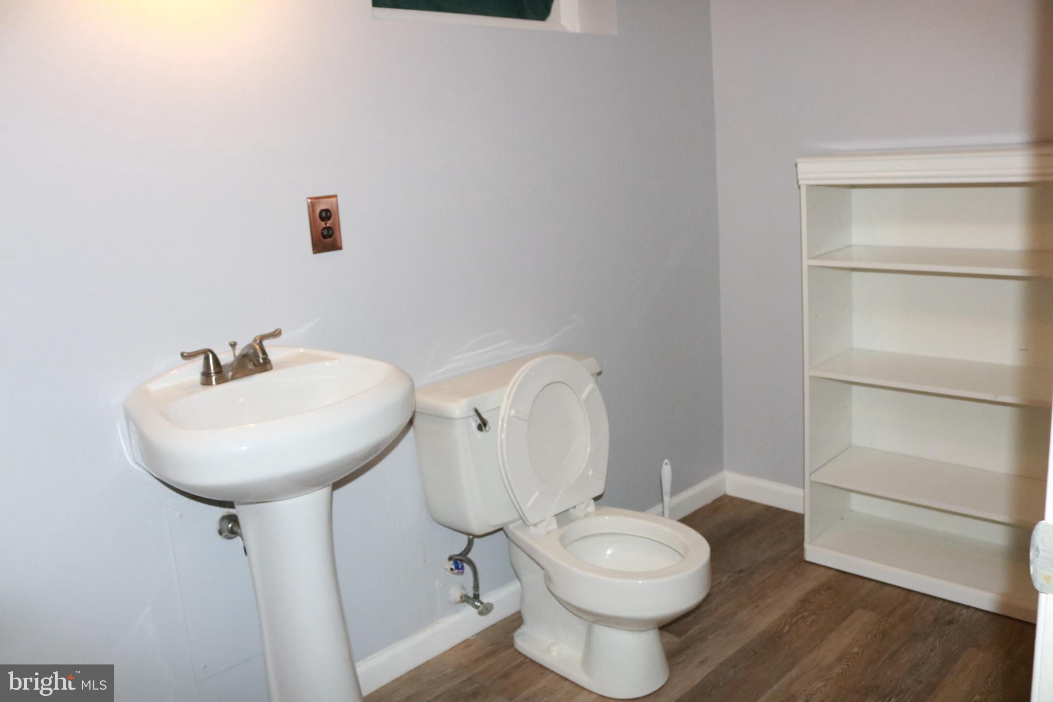 3822 Cassandra Road Randallstown, MD 21133 - Photo 13 of 24 a bathroom with a toilet a sink and a mirror