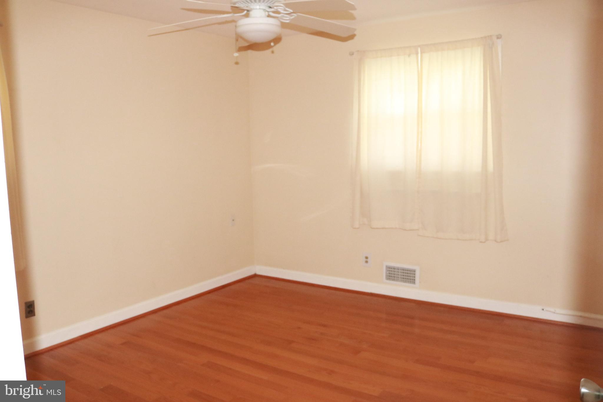 3822 Cassandra Road Randallstown, MD 21133 - Photo 21 of 24 an empty room with wooden floor and fan