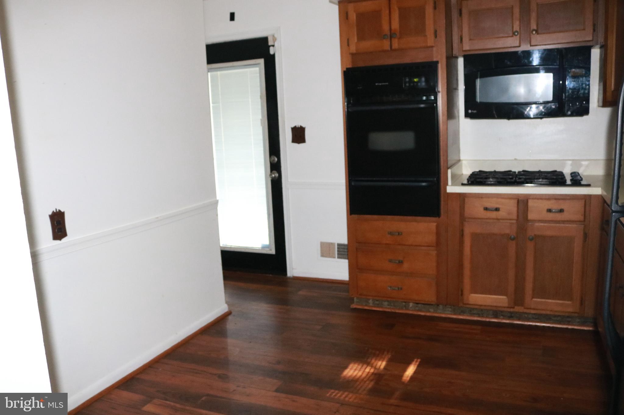 3822 Cassandra Road Randallstown, MD 21133 - Photo 3 of 24 a view of a hallway with wooden floor and staircase