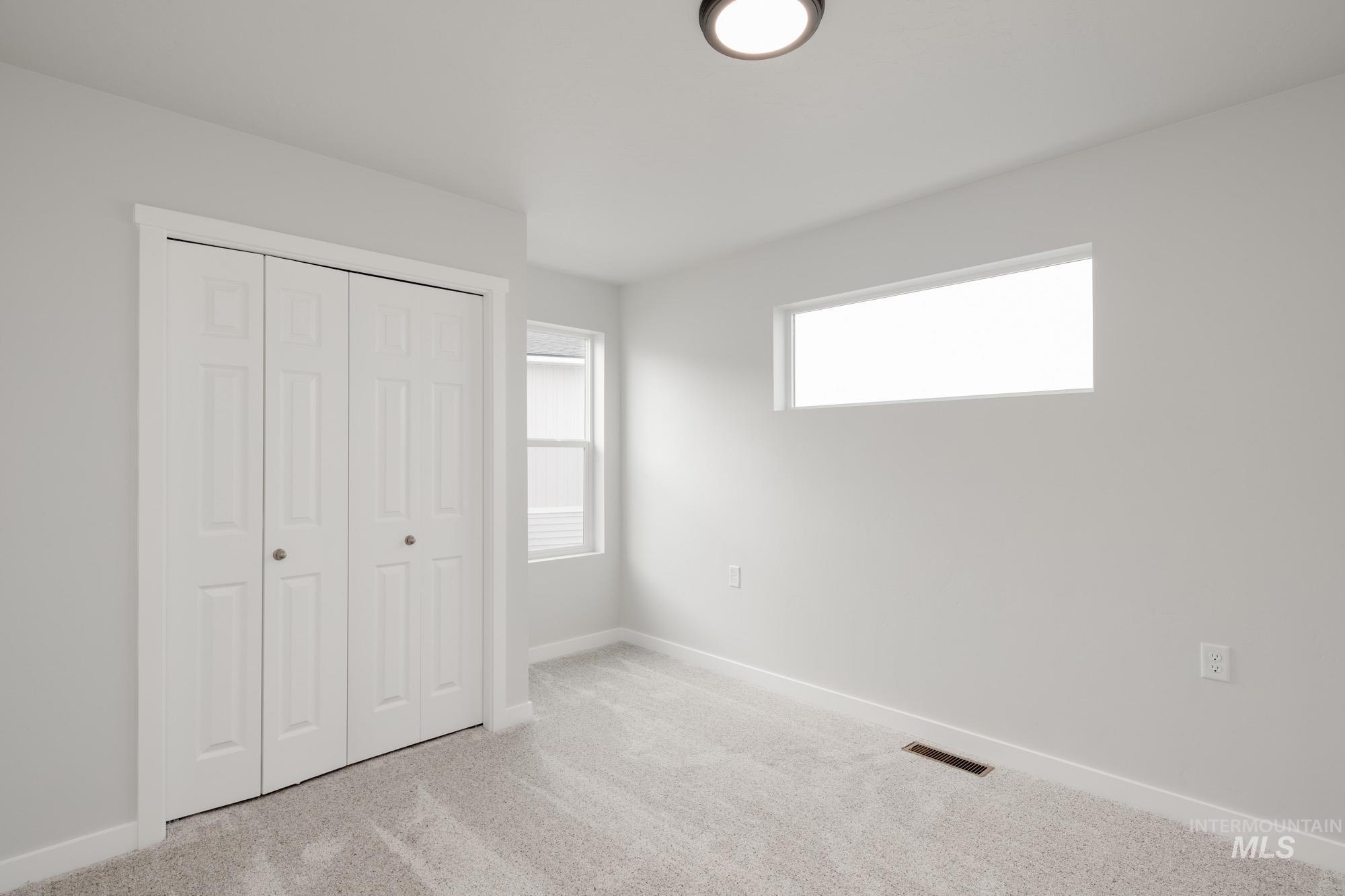 2486 West Fallon Loop Nampa, ID 83651 - Photo 17 of 18 Unfurnished bedroom featuring carpet and a closet