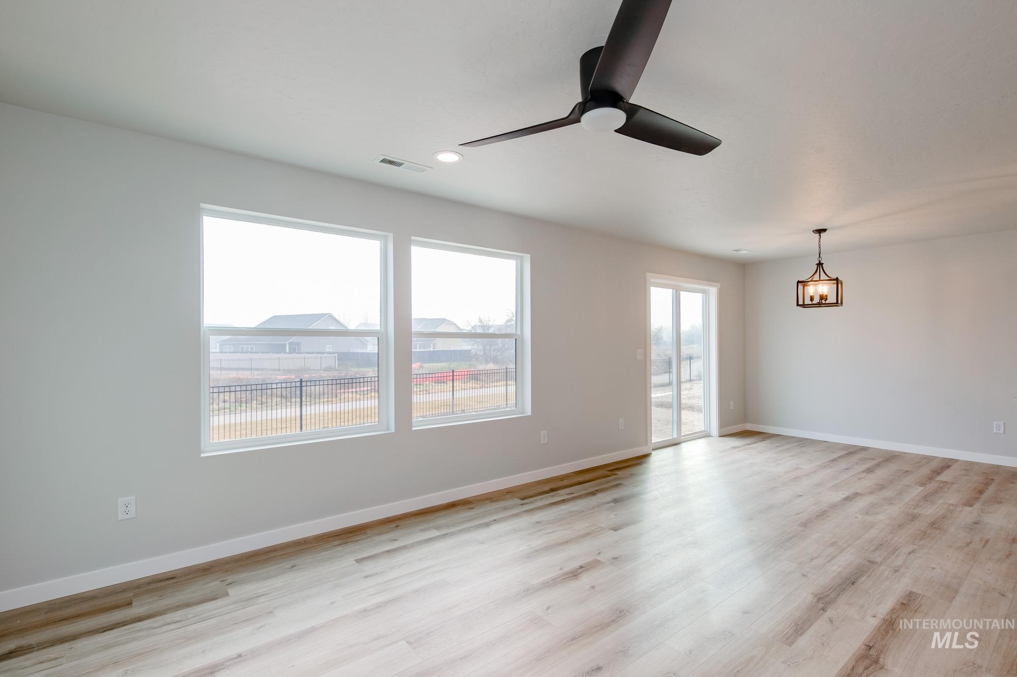 2486 West Fallon Loop Nampa, ID 83651 - Photo 5 of 18 Unfurnished room with light wood-style flooring, a ceiling fan, and recessed lighting