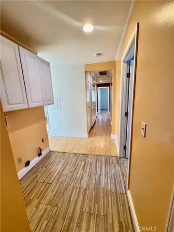 a view of a room with wooden floor and staircase