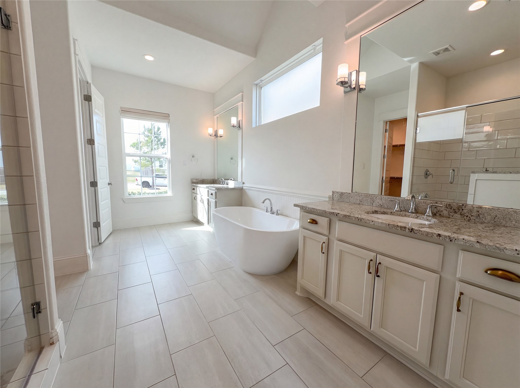 2333 Goldenglade Drive Conroe, TX 77384 - Photo 15 of 21 a bathroom with a granite countertop sink a toilet a mirror and bathtub