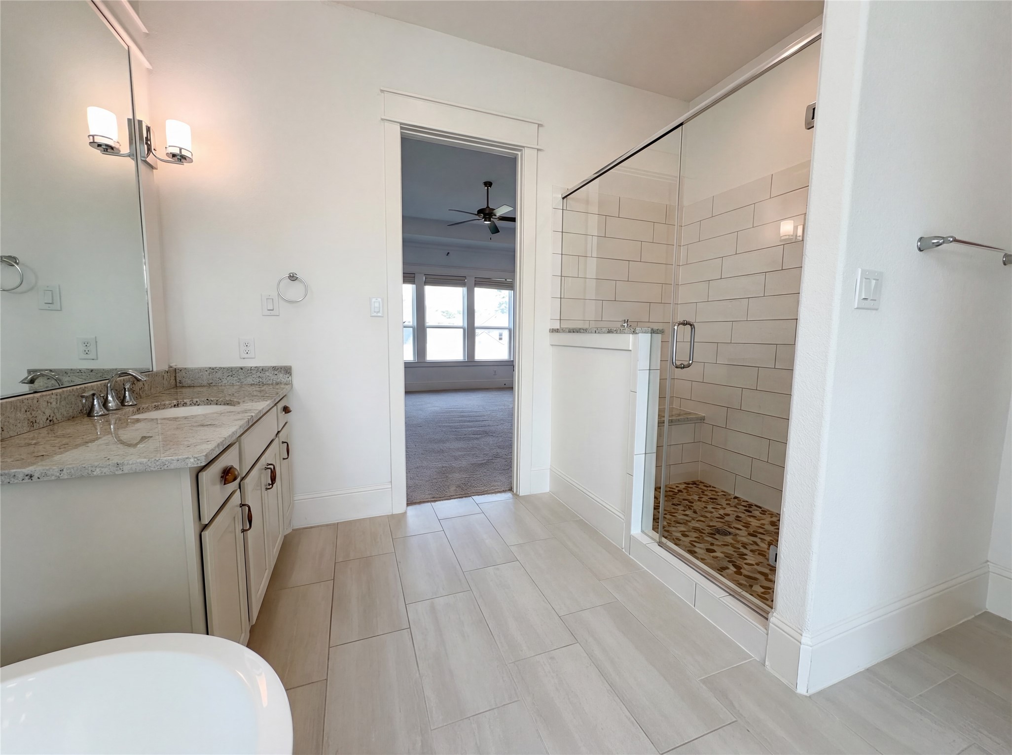 2333 Goldenglade Drive Conroe, TX 77384 - Photo 16 of 21 a bathroom with a granite countertop sink toilet and shower