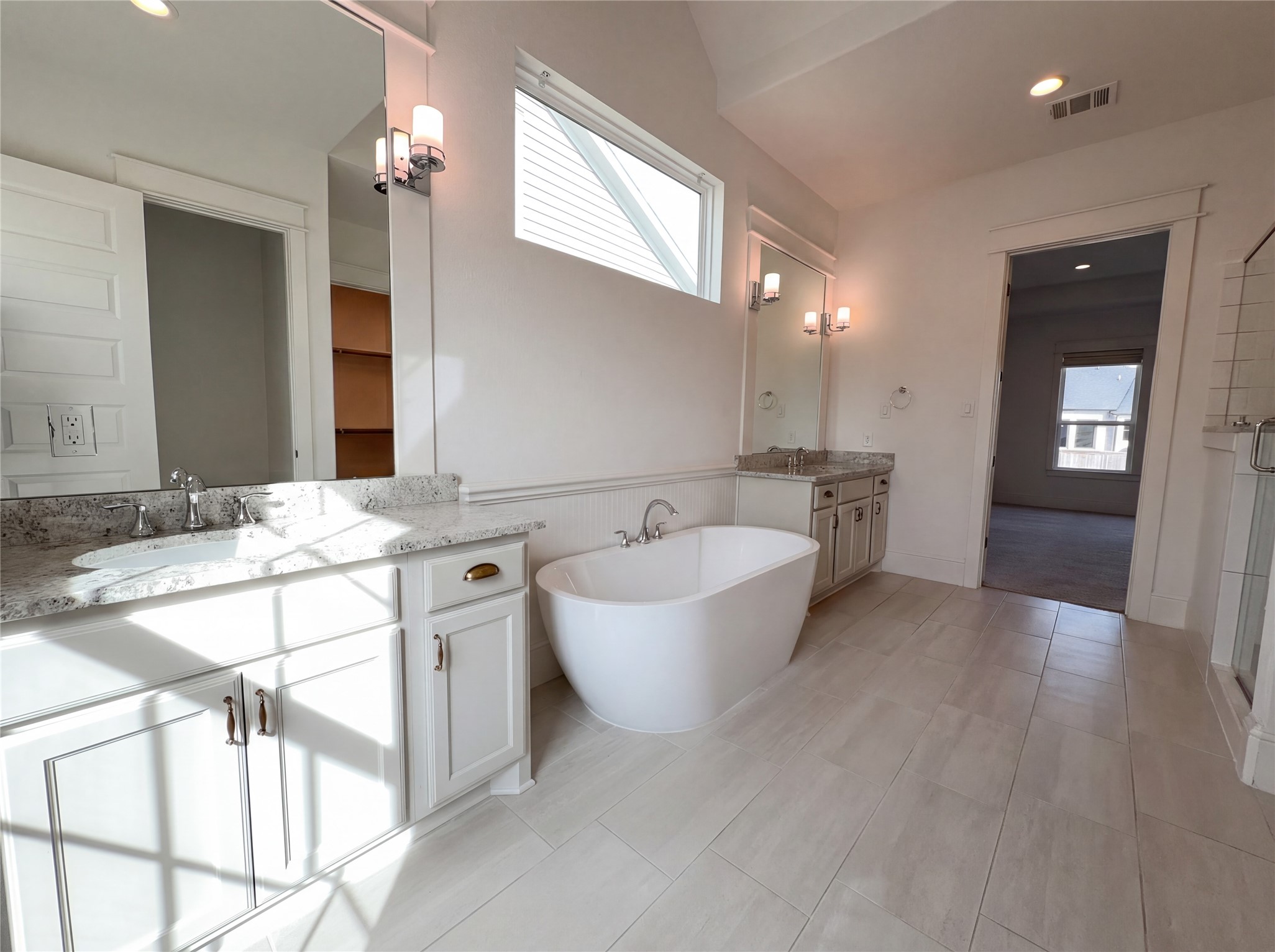 2333 Goldenglade Drive Conroe, TX 77384 - Photo 17 of 21 a spacious bathroom with a granite countertop sink mirror and bathtub