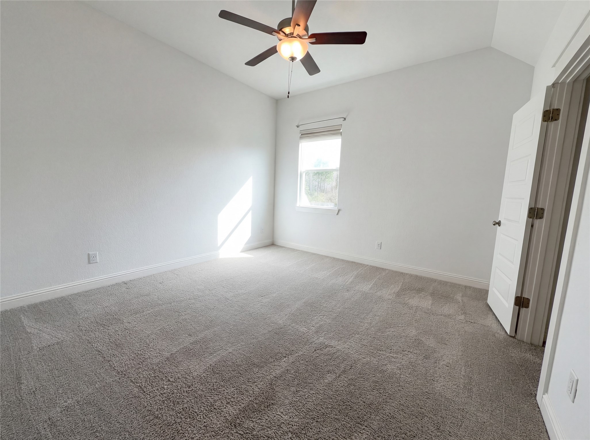 2333 Goldenglade Drive Conroe, TX 77384 - Photo 19 of 21 an empty room with windows and fan