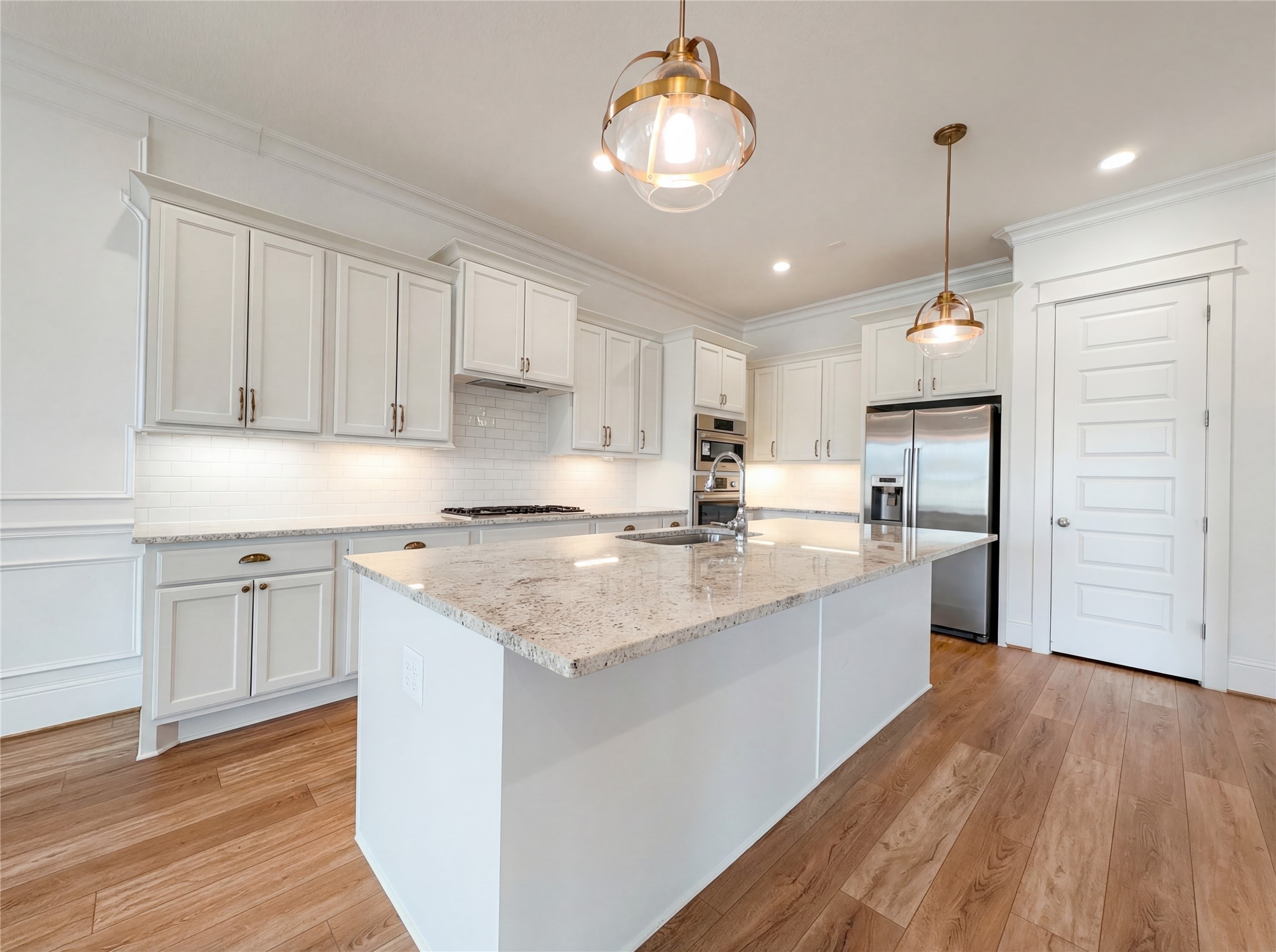 2333 Goldenglade Drive Conroe, TX 77384 - Photo 2 of 21 a kitchen with stainless steel appliances granite countertop a sink refrigerator and cabinets