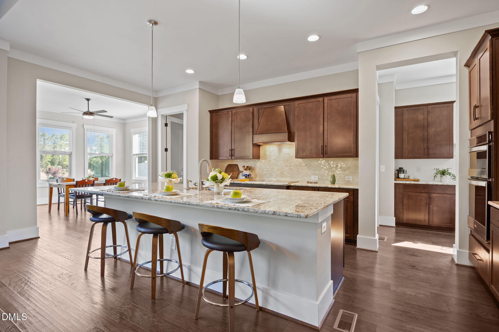 1324 Spicer Lane Rolesville, NC 27571 - Photo 10 of 59 a kitchen with stainless steel appliances granite countertop a stove a refrigerator a kitchen island a dining table and chairs