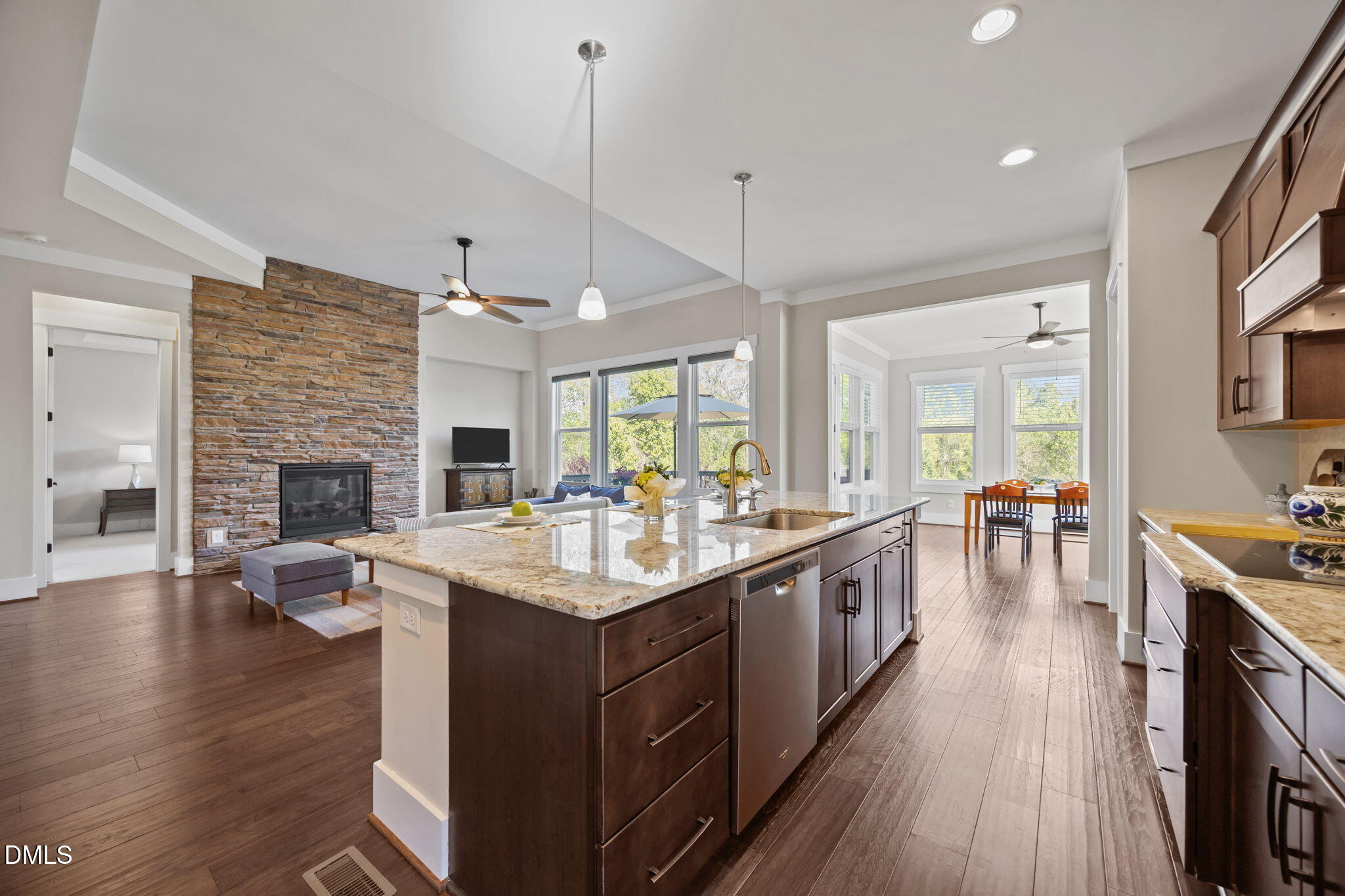 1324 Spicer Lane Rolesville, NC 27571 - Photo 12 of 59 a large kitchen with kitchen island a sink dishwasher a stove a dining table and chairs with wooden floor