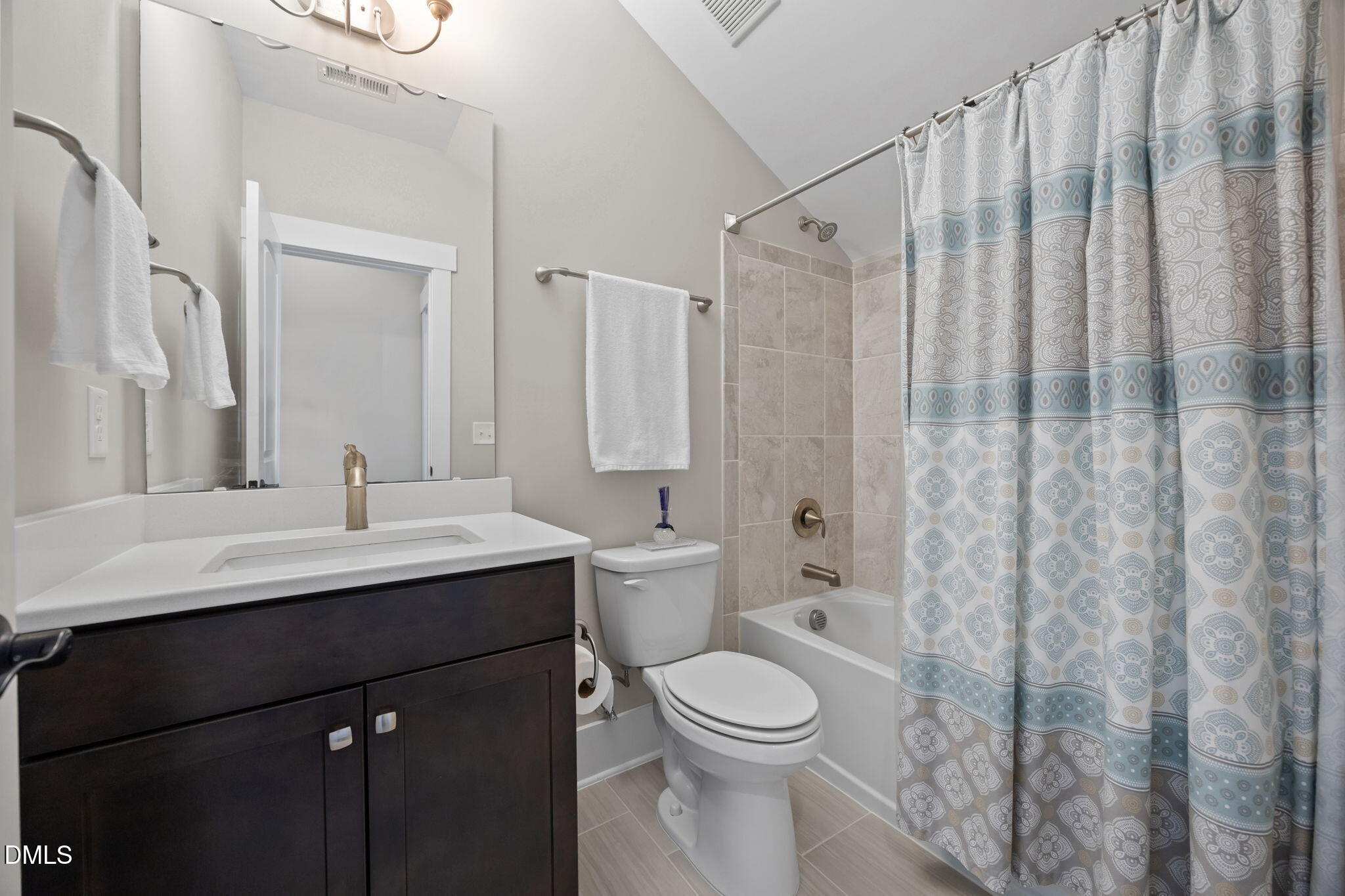 1324 Spicer Lane Rolesville, NC 27571 - Photo 40 of 59 a bathroom with a toilet a sink and a mirror