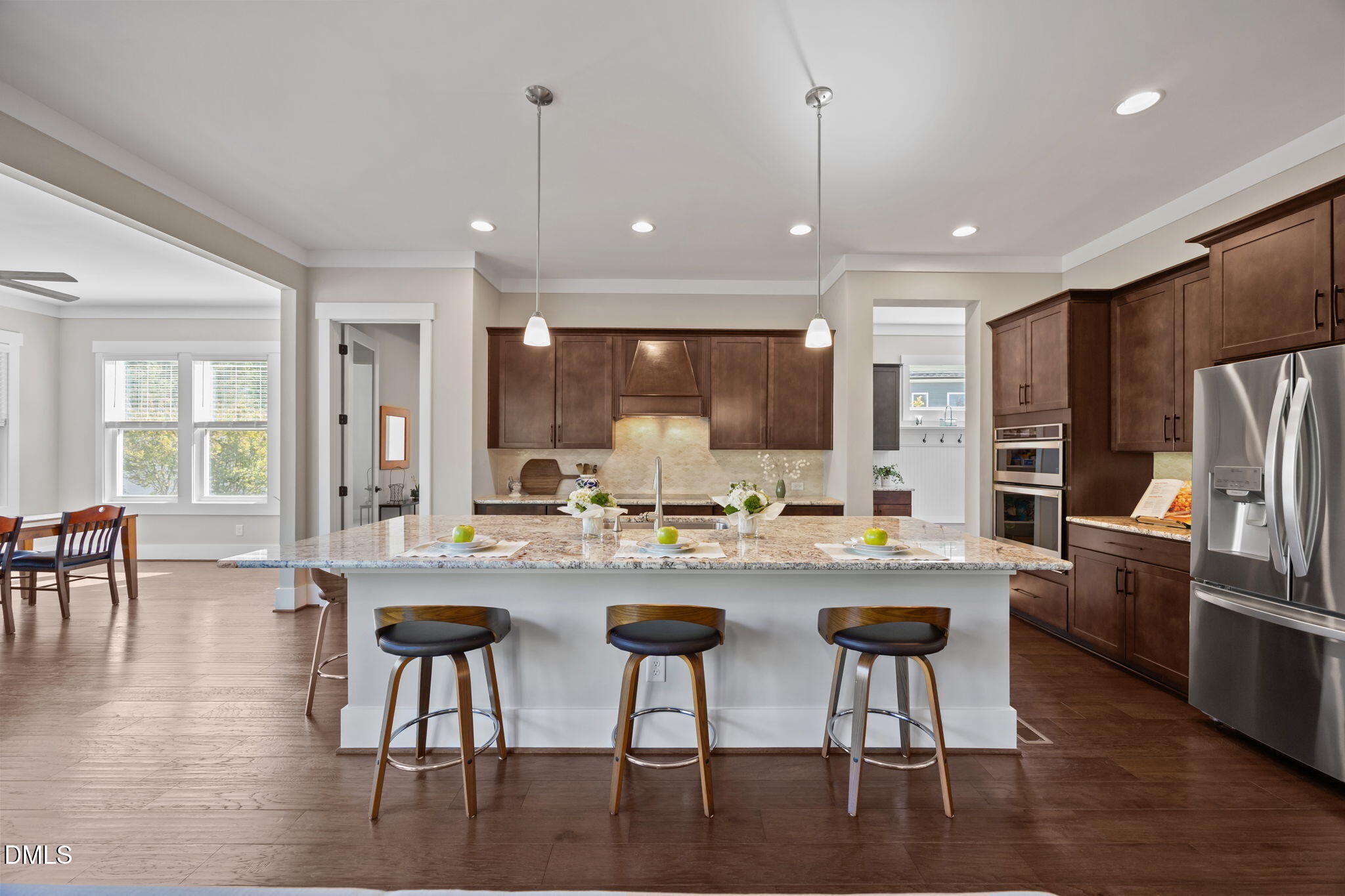 1324 Spicer Lane Rolesville, NC 27571 - Photo 5 of 59 a kitchen with stainless steel appliances granite countertop a stove a refrigerator a kitchen island a dining table and chairs