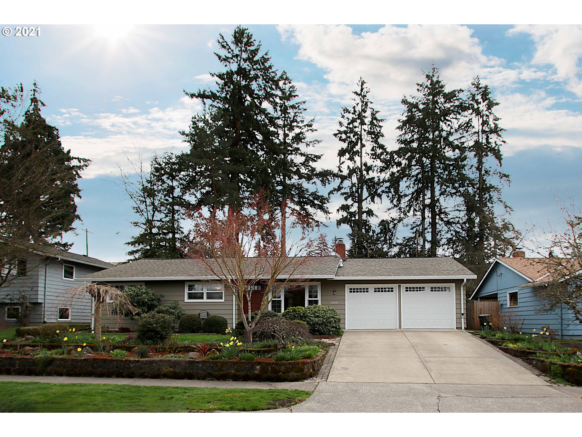 12740 Southwest Foothill Drive Portland, OR 97225 - Photo 1 of 27 a view of house in front of a big yard with large trees
