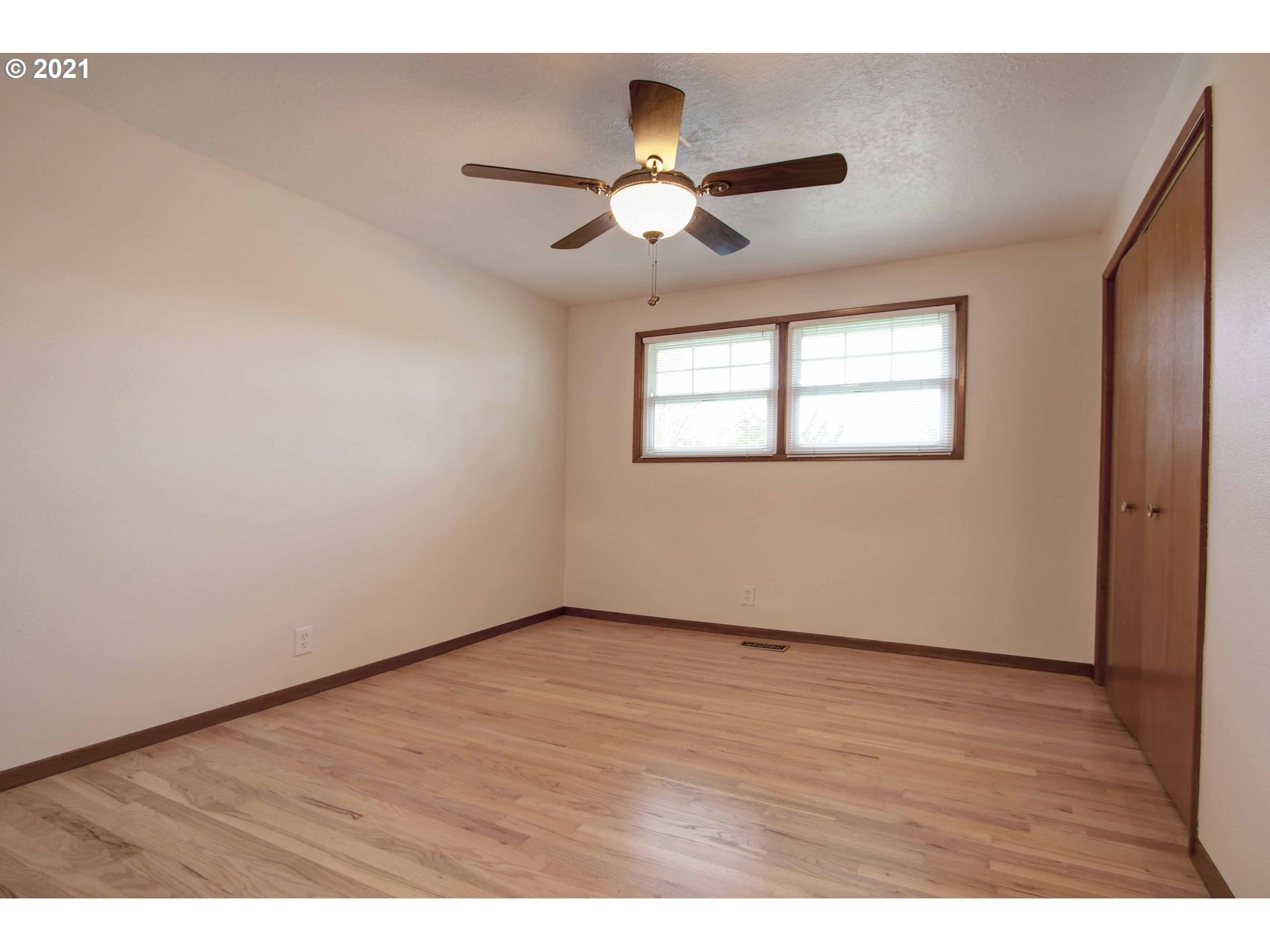 12740 Southwest Foothill Drive Portland, OR 97225 - Photo 12 of 27 a view of an empty room with wooden floor and a window