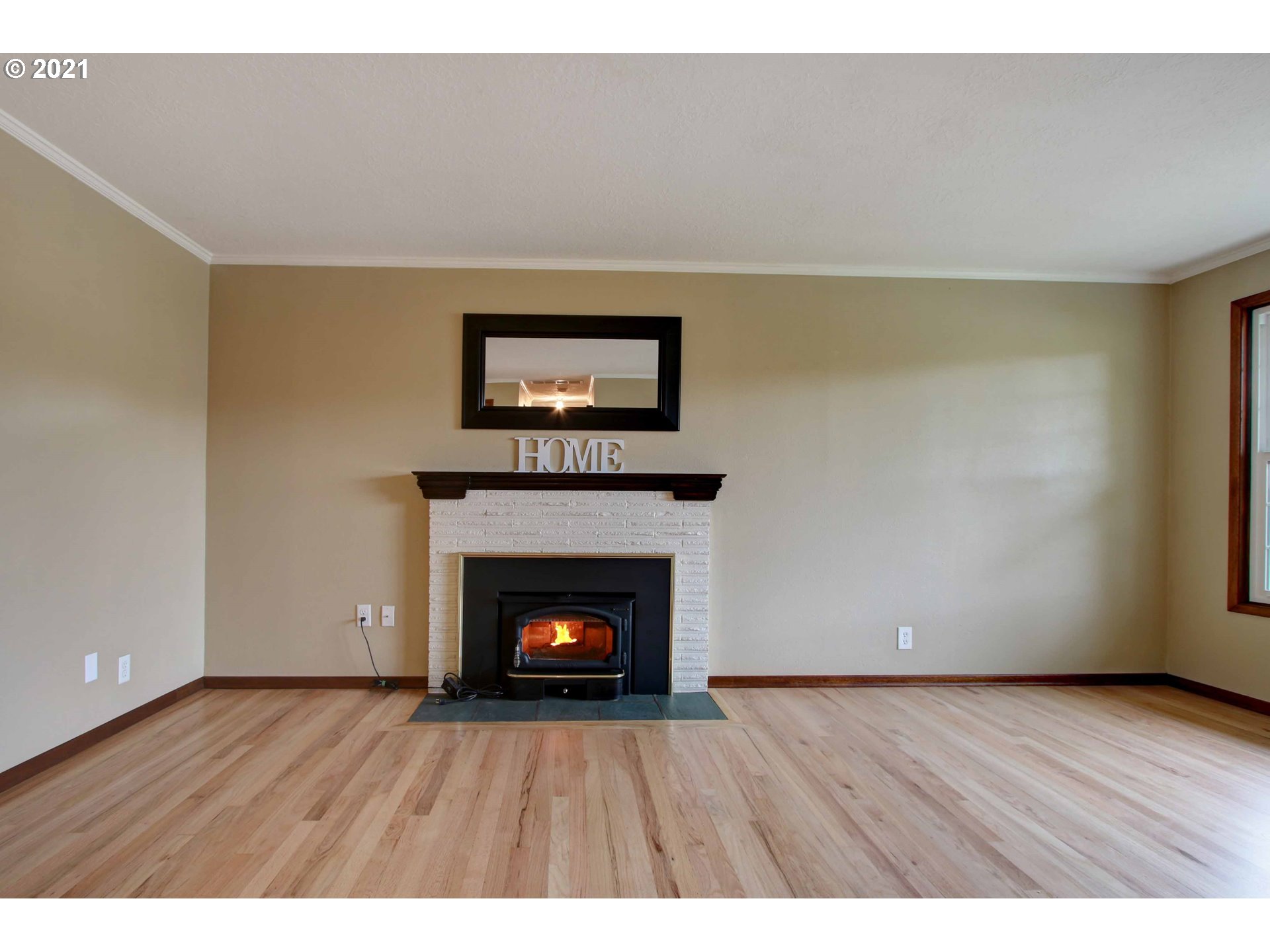 12740 Southwest Foothill Drive Portland, OR 97225 - Photo 2 of 27 a view of an empty room with wooden floor fireplace and a window