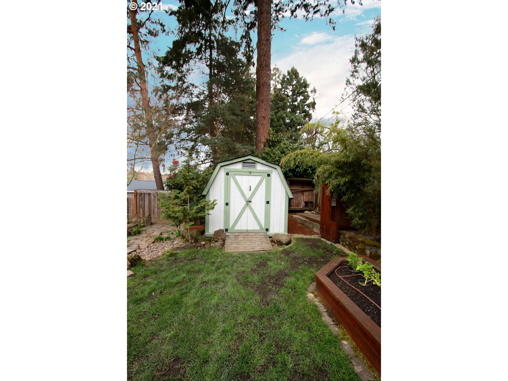 12740 Southwest Foothill Drive Portland, OR 97225 - Photo 24 of 27 a backyard of a house with a yard and garage