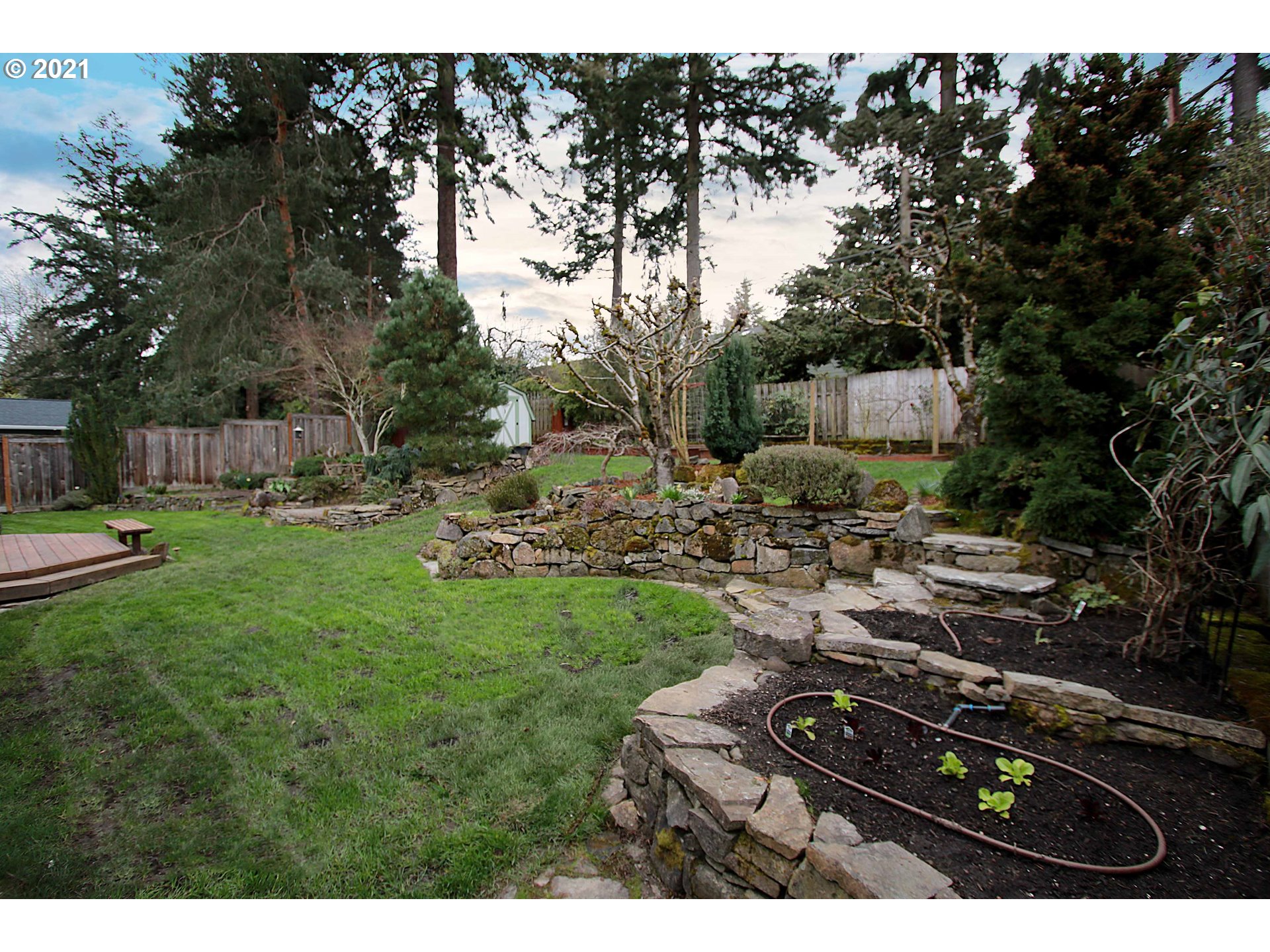 12740 Southwest Foothill Drive Portland, OR 97225 - Photo 26 of 27 a backyard of a house with table and chairs