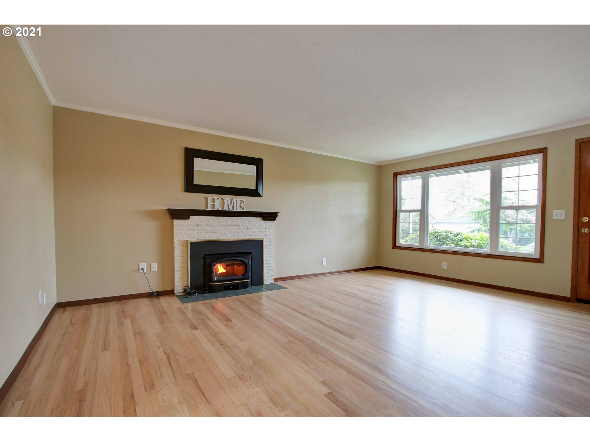 12740 Southwest Foothill Drive Portland, OR 97225 - Photo 4 of 27 a view of an empty room with a window and fireplace