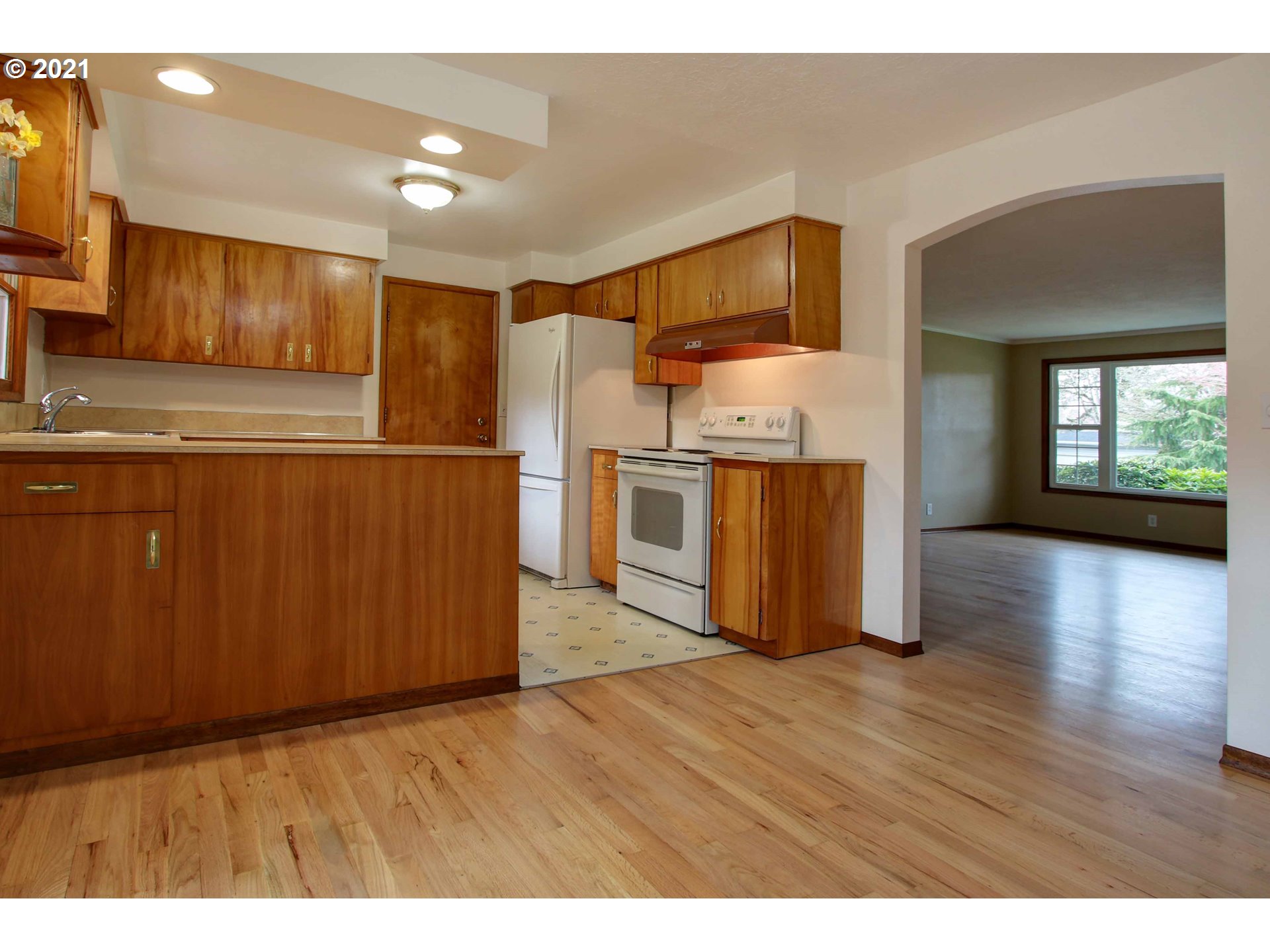 12740 Southwest Foothill Drive Portland, OR 97225 - Photo 9 of 27 a kitchen with stainless steel appliances granite countertop a refrigerator a stove top oven a sink and dishwasher with wooden floor