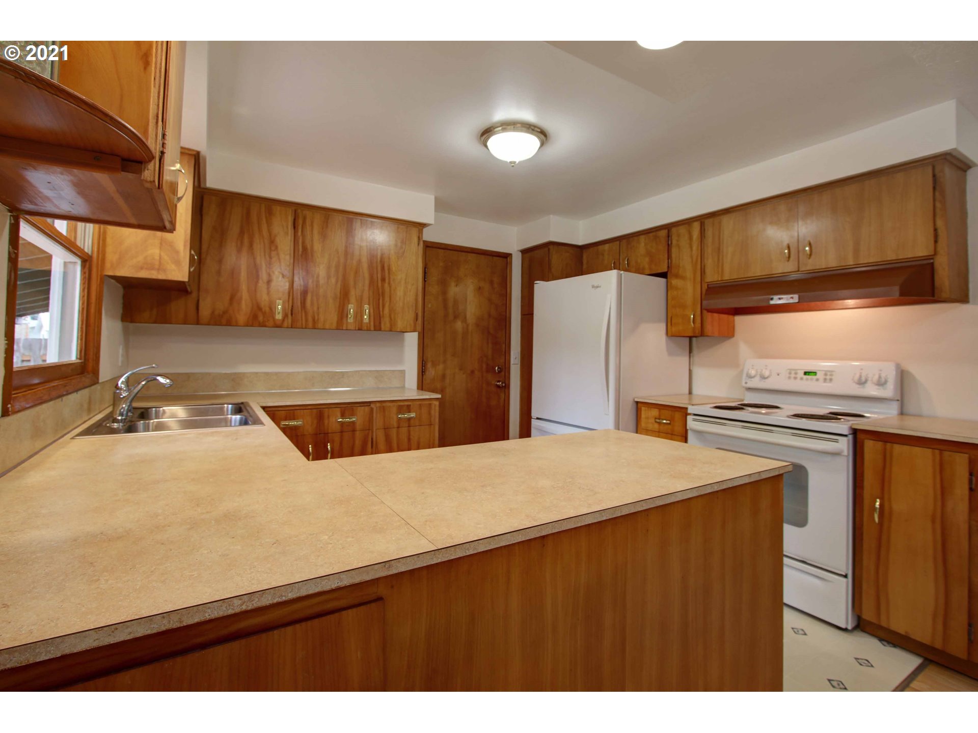 12740 Southwest Foothill Drive Portland, OR 97225 - Photo 10 of 27 a kitchen with stainless steel appliances a sink stove and refrigerator