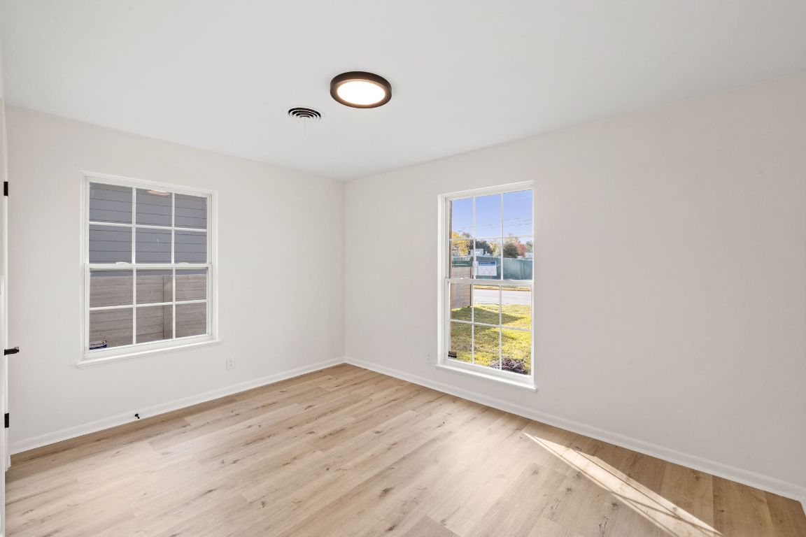 3012 Hunt Trail Austin, TX 78757 - Photo 17 of 29 an empty room with wooden floor and windows