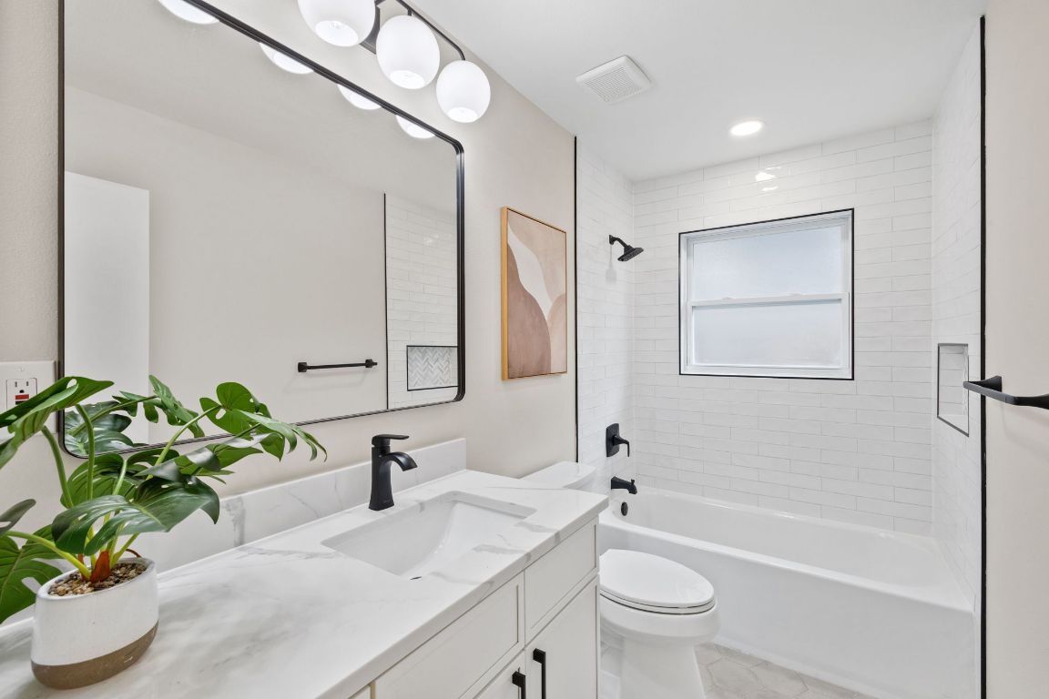 3012 Hunt Trail Austin, TX 78757 - Photo 20 of 29 a bathroom with a sink a toilet and a mirror