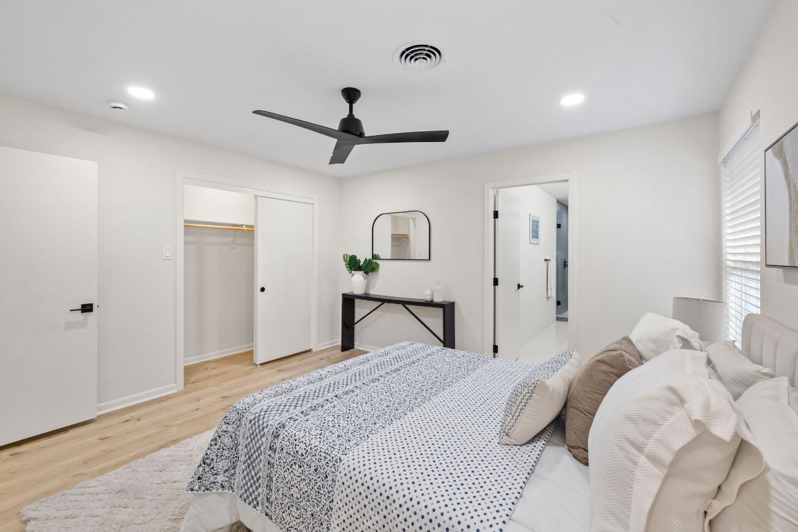 3012 Hunt Trail Austin, TX 78757 - Photo 22 of 29 a bedroom with a bed and a chandelier