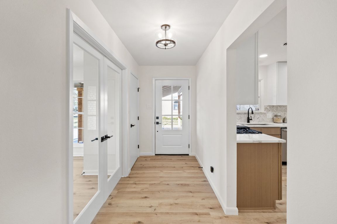 3012 Hunt Trail Austin, TX 78757 - Photo 4 of 29 a view of a hallway with wooden floor and cabinets
