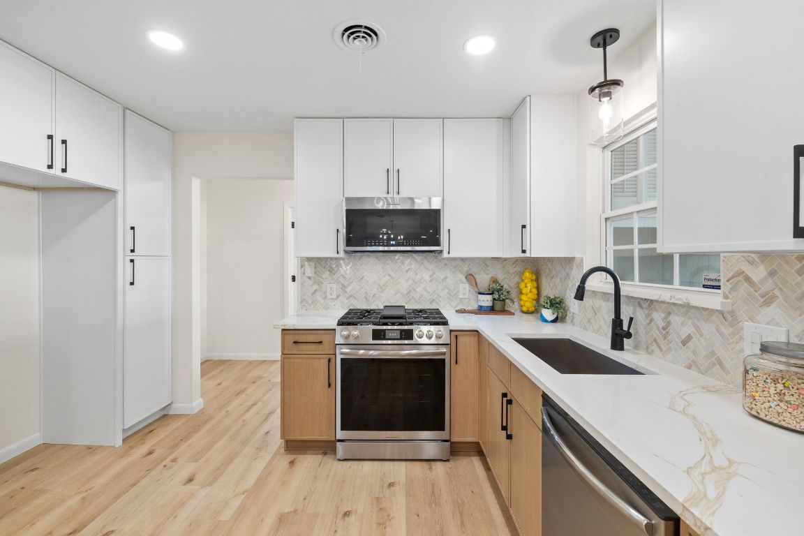 3012 Hunt Trail Austin, TX 78757 - Photo 8 of 29 a kitchen with a sink stove and refrigerator