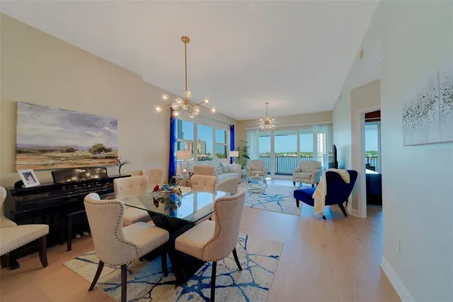 a large bedroom with a large bed and a chandelier