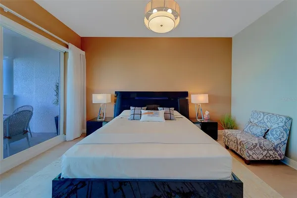 a bathroom with a granite countertop toilet sink and mirror