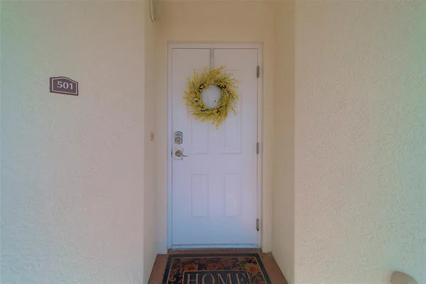 a kitchen with stainless steel appliances a sink a stove a refrigerator cabinets and a center island